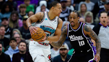 Mar 17, 2025; Sacramento, California, USA; Memphis Grizzlies guard Desmond Bane (22) controls the ball against Sacramento Kings forward DeMar DeRozan (10) during the first quarter at Golden 1 Center. Mandatory Credit: Sergio Estrada-Imagn Images