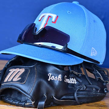 Mar 15, 2024; Salt River Pima-Maricopa, Arizona, USA; General view of a Texas Rangers hat, glove, and glasses prior to a spring training game against the Colorado Rockies at Salt River Fields at Talking Stick.