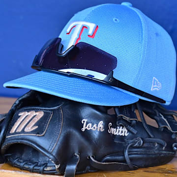 General view of a Texas Rangers hat, glove, and glasses prior to a spring training game against the Colorado Rockies at Salt River Fields at Talking Stick. 