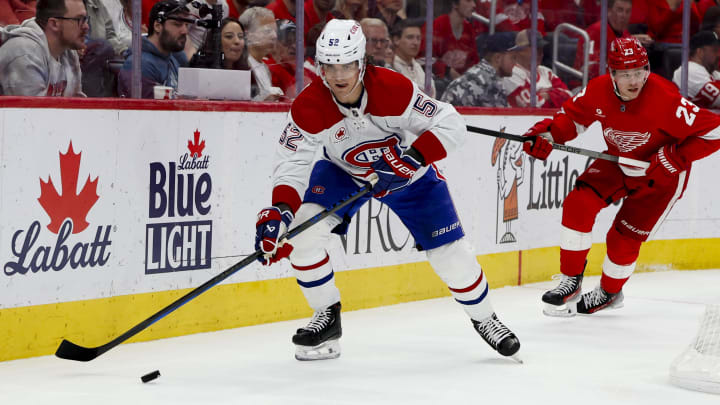 Apr 15, 2024; Detroit, Michigan, USA;  Montreal Canadiens defenseman Justin Barron (52) skates with the puck while chased by Detroit Red Wings left wing Lucas Raymond (23) in the second period at Little Caesars Arena. Mandatory Credit: Rick Osentoski-USA TODAY Sports