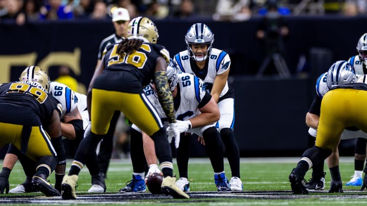 Carolina Panthers quarterback Bryce Young (9) eyes New Orleans Saints linebacker Demario Davis (56)