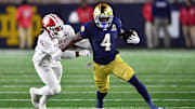 Dec 20, 2024; Notre Dame, Indiana, USA; Notre Dame Fighting Irish running back Jeremiyah Love (4) runs against Indiana Hoosiers linebacker Rolijah Hardy (21) during the third quarter at Notre Dame Stadium. Mandatory Credit: Matt Cashore-Imagn Images