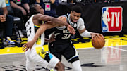 Apr 22, 2025; Indianapolis, Indiana, USA; Milwaukee Bucks forward Giannis Antetokounmpo (34) dribbles the ball while Indiana Pacers forward Aaron Nesmith (23) defends during game two of first round for the 2024 NBA Playoffs at Gainbridge Fieldhouse. Mandatory Credit: Trevor Ruszkowski-Imagn Images
