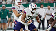 Oct 18, 2025; Tampa, Florida, USA;  Florida Atlantic Owls offensive lineman Daughtry Richardson (78) guards his quarterback  Caden Veltkamp (10) against the rush from South Florida Bulls defensive end Dennard Flowers (15) during the second quarter at Raymond James Stadium. Mandatory Credit: Reinhold Matay-Imagn Images