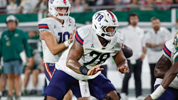 Oct 18, 2025; Tampa, Florida, USA;  Florida Atlantic Owls offensive lineman Daughtry Richardson (78) guards his quarterback  Caden Veltkamp (10) against the rush from South Florida Bulls defensive end Dennard Flowers (15) during the second quarter at Raymond James Stadium. Mandatory Credit: Reinhold Matay-Imagn Images