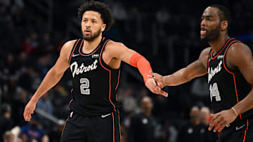 Detroit Pistons guard Cade Cunningham (2) celebrates with guard Alec Burks (14) at center court after making a basket against the Washington Wizards in the second quarter at Little Caesars Arena. Mandatory Credit: Lon Horwedel-Imagn Images