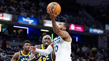 Mar 24, 2025; Indianapolis, Indiana, USA; Minnesota Timberwolves guard Mike Conley (10) shoots the ball while Indiana Pacers forward Pascal Siakam (43)  defends in the first half at Gainbridge Fieldhouse. Mandatory Credit: Trevor Ruszkowski-Imagn Images