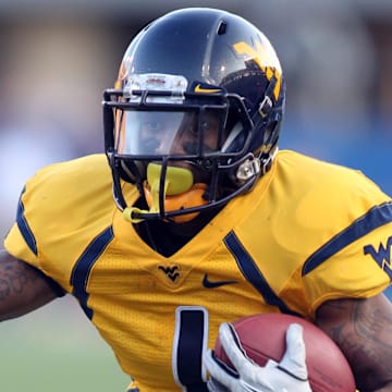 December 1, 2012; Morgantown, WV, USA; West Virginia Mountaineers wide receiver Tavon Austin (1) carries the ball against the Kansas Jayhawks during the third quarter at Milan Puskar Field. The West Virginia Mountaineers won 59-10. Mandatory Credit: Charles LeClaire-Imagn Images