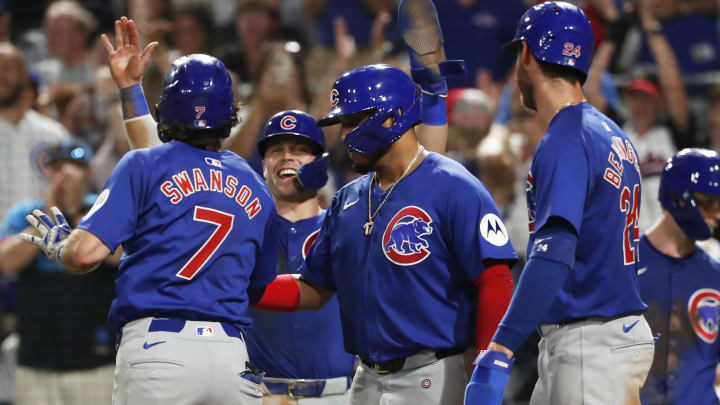 Aug 26, 2024; Pittsburgh, Pennsylvania, USA;  Chicago Cubs second baseman Nico Hoerner (LC) and third baseman Isaac Paredes (RC) and right fielder Cody Bellinger (24) greet shortstop Dansby Swanson (7) crossing home plate on a grand slam home run against the Pittsburgh Pirates during the sixth inning at PNC Park.