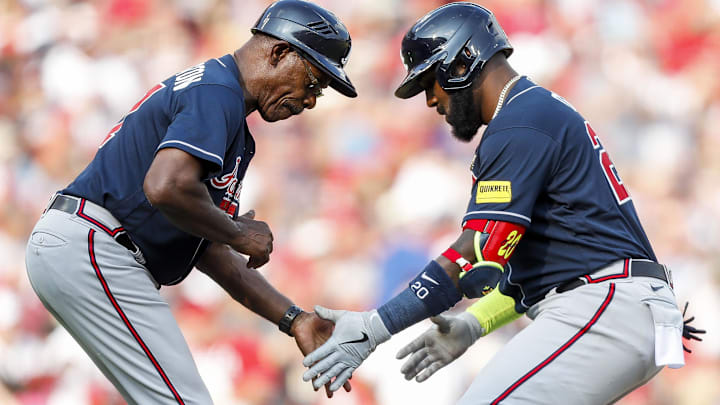 Jun 24, 2023; Cincinnati, Ohio, USA; Atlanta Braves designated hitter Marcell Ozuna (20) celebrates with third base coach Ron Washington (37) after hitting a solo home run in the seventh inning at Great American Ball Park. Mandatory Credit: Katie Stratman-Imagn Images