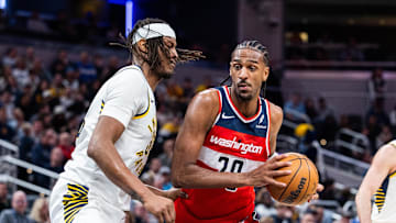 Apr 8, 2025; Indianapolis, Indiana, USA; Washington Wizards forward Alex Sarr (20) dribbles the ball while Indiana Pacers center Myles Turner (33)  defends in the second half at Gainbridge Fieldhouse. Mandatory Credit: Trevor Ruszkowski-Imagn Images