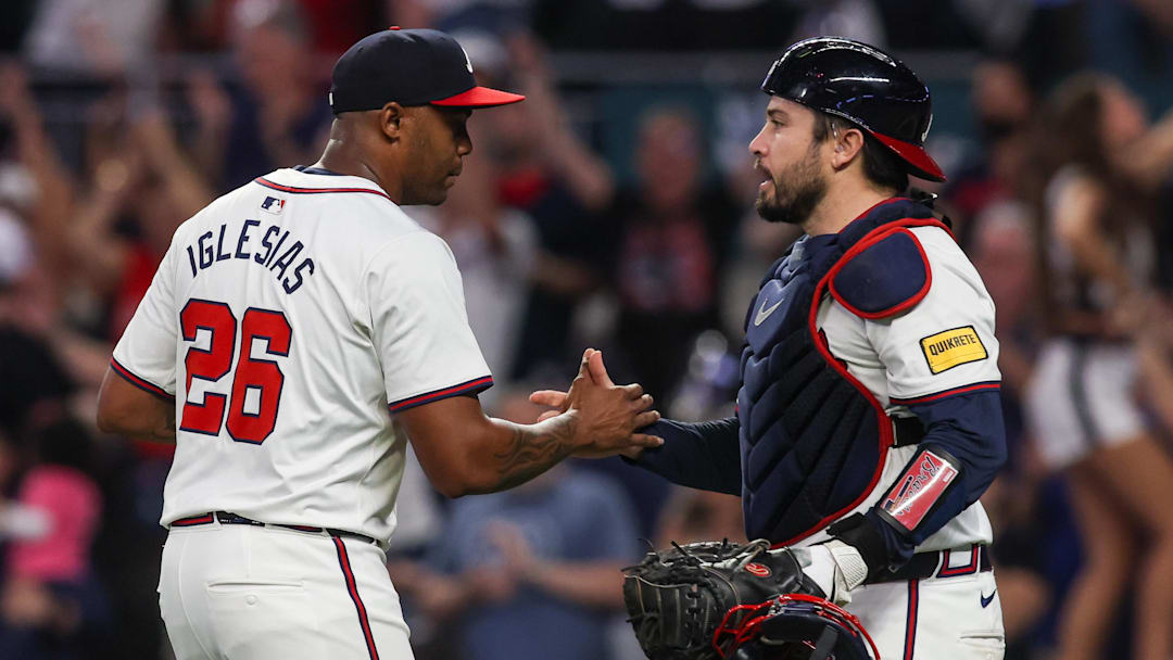 Sep 24, 2024; Atlanta, Georgia, USA; Atlanta Braves relief pitcher Raisel Iglesias (26) and catcher Travis d'Arnaud (16) celebrate after a victory over the New York Mets at Truist Park. Mandatory Credit: Brett Davis-Imagn Images
