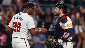 Sep 24, 2024; Atlanta, Georgia, USA; Atlanta Braves relief pitcher Raisel Iglesias (26) and catcher Travis d'Arnaud (16) celebrate after a victory over the New York Mets at Truist Park. Mandatory Credit: Brett Davis-Imagn Images
