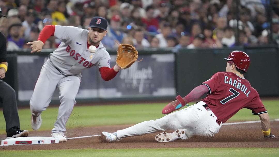 Arizona Diamondbacks' Corbin Carroll (7) steals third base as Boston Red Sox third baseman Alex Bregman (2) fields the throw during the fourth inning at Chase Field on Sept. 7, 2025.