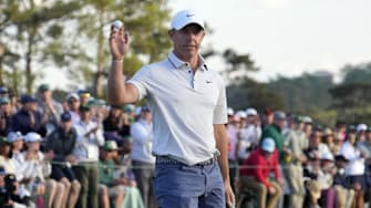 Rory McIlroy reacts after putting on the 18th green during the third round of the Masters Tournament at Augusta National Golf Club. 