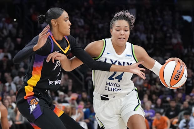 Minnesota Lynx forward Napheesa Collier drives the ball against Phoenix Mercury forward DeWanna Bonner. 