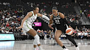 Sep 4, 2025; Las Vegas, Nevada, USA; Las Vegas Aces center A'ja Wilson (22) drives past Minnesota Lynx forward Napheesa Collier (24) in the first quarter of their game at T-Mobile Arena. Mandatory Credit: Candice Ward-Imagn Images