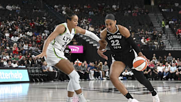 Sep 4, 2025; Las Vegas, Nevada, USA; Las Vegas Aces center A'ja Wilson (22) drives past Minnesota Lynx forward Napheesa Collier (24) in the first quarter of their game at T-Mobile Arena. Mandatory Credit: Candice Ward-Imagn Images