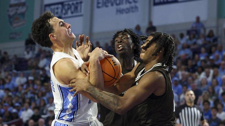 Nov 25, 2025; Fort Myers, Florida, USA; North Carolina Tar Heels guard Luka Bogavac (44) collides with St. St. Bonaventure Bonnies guard Amar’E Marshall (2) and center Andrew Osasuyi (33) in the first half at Suncoast Credit Union Arena. Mandatory Credit: Nathan Ray Seebeck-Imagn Images