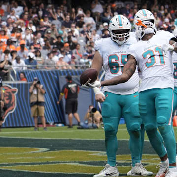 Miami Dolphins running back Ollie Gordon II (31) celebrates his touchdown against the Chicago Bears during the second half at Soldier Field on Sunday.