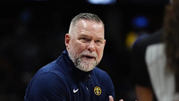 Apr 6, 2025; Denver, Colorado, USA; Denver Nuggets head coach Michael Malone reacts towards referee Danielle Scott (87) in the second half against the Indiana Pacers at Ball Arena. Mandatory Credit: Ron Chenoy-Imagn Images
