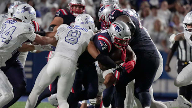 Terrel Bernard turns and gets an arm out to stop New England Patriots running back Antonio Gibson