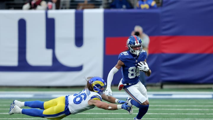 Dec 31, 2023; East Rutherford, New Jersey, USA; New York Giants wide receiver Darius Slayton (86) runs with the ball against Los Angeles Rams linebacker Christian Rozeboom (56) during the fourth quarter at MetLife Stadium. 