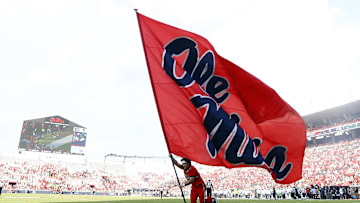 Sep 20, 2025; Oxford, Mississippi, USA; Mississippi Rebels cheerleader run an Ole Miss flag through the end zone after a touchdown during the fourth quarter against the Tulane Green Wave at Vaught-Hemingway Stadium. Mandatory Credit: Petre Thomas-Imagn Images