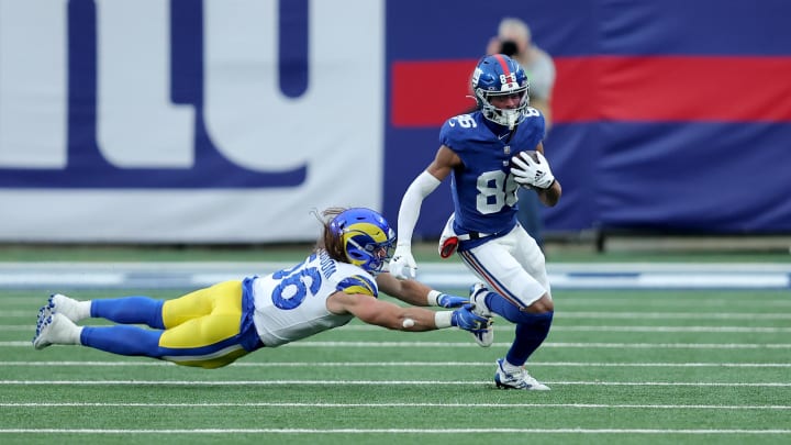 Dec 31, 2023; East Rutherford, New Jersey, USA; New York Giants wide receiver Darius Slayton (86) runs with the ball against Los Angeles Rams linebacker Christian Rozeboom (56) during the fourth quarter at MetLife Stadium.  