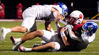 Covington Catholic Colonels Cash Myers (4) and Owen Pitzer (22) tackle Beechwood Tigers quarterback Emmett Queen in the second half of a high school football between the Covington Catholic Colonels and Beechwood Tigers, Friday, Sept. 19, 2025, at the Beechwood Tiger’s home field in Fort Mitchell, Ky. Colonels won 42-14.