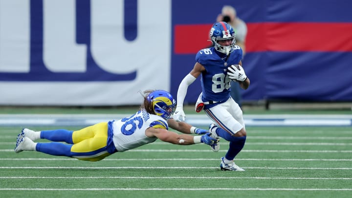 Dec 31, 2023; East Rutherford, New Jersey, USA; New York Giants wide receiver Darius Slayton (86) runs with the ball against Los Angeles Rams linebacker Christian Rozeboom (56) during the fourth quarter at MetLife Stadium. Mandatory Credit: Brad Penner-USA TODAY Sports