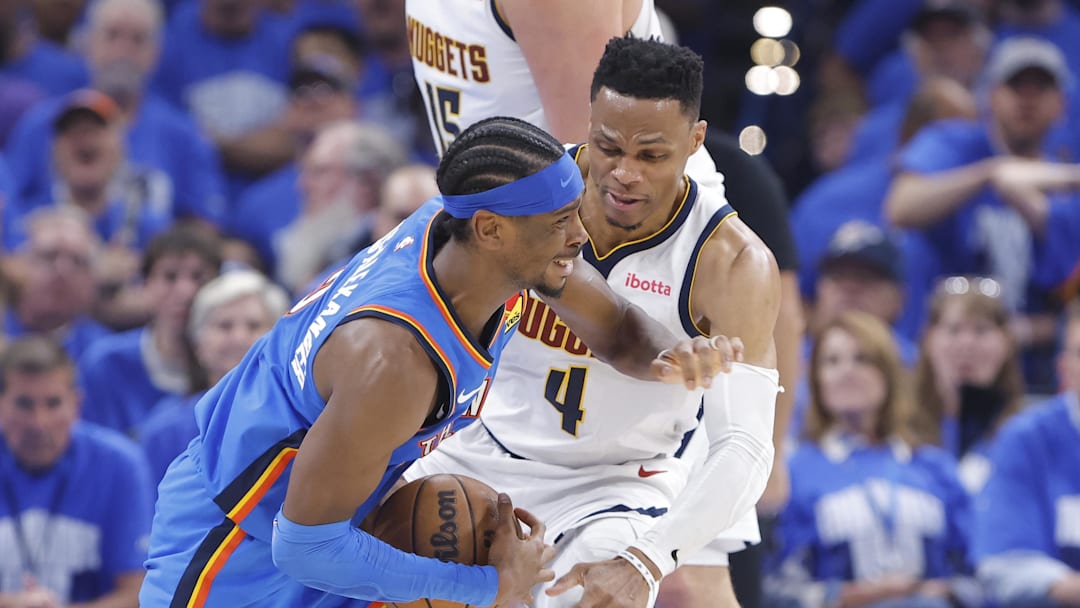 May 18, 2025; Oklahoma City, Oklahoma, USA; Oklahoma City Thunder guard Shai Gilgeous-Alexander (2) is fouled by Denver Nuggets guard Russell Westbrook (4) on a drive in the second quarter during game seven of the second round for the 2025 NBA Playoffs at Paycom Center. Mandatory Credit: Alonzo Adams-Imagn Images