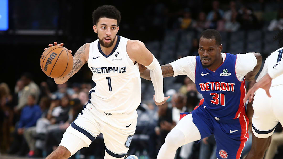 Oct 6, 2025; Memphis, Tennessee, USA; Memphis Grizzlies guard Scotty Pippen Jr. (1) dribbles around a screen set by forward Olivier-Maxence Prosper (18) on Detroit Pistons guard Javonte Green (31) during the fourth quarter at FedExForum.