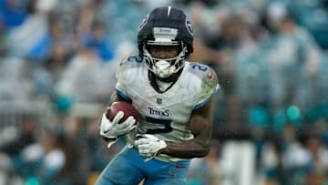 Dec 29, 2024; Jacksonville, Florida, USA; Tennessee Titans running back Tyjae Spears (2) runs the ball against the Jacksonville Jaguars in the second quarter at EverBank Stadium. Mandatory Credit: Jeremy Reper-Imagn Images