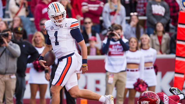 Auburn Tigers quarterback Payton Thorne (1) scores a touchdown and looks back