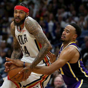 Mar 27, 2022; New Orleans, Louisiana, USA; New Orleans Pelicans forward Brandon Ingram (14) is defended by Los Angeles Lakers guard Talen Horton-Tucker (5) in the second half at the Smoothie King Center. The Pelicans won, 116-108. Mandatory Credit: Chuck Cook-Imagn Images