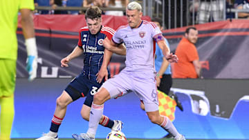 Orlando City SC defender Robin Jansson (6) defends against New England Revolution forward Malcolm Fry (32) 
