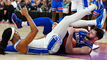 Nov 26, 2024; Las Vegas, Nevada, USA; Kansas Jayhawks center Hunter Dickinson (1) and Duke Blue Devils forward Maliq Brown (6) fall to the floor during the second half at T-Mobile Arena. Mandatory Credit: Stephen R. Sylvanie-Imagn Images