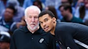 Dec 23, 2023; Dallas, Texas, USA; San Antonio Spurs head coach Gregg Popovich speaks with San Antonio Spurs center Victor Wembanyama (1) before the game against the Dallas Mavericks at American Airlines Center. Mandatory Credit: Kevin Jairaj-Imagn Images