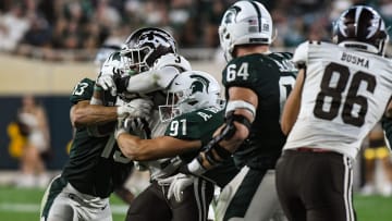 MSU DT Alex VanSumeren (97) and LB Ben VanSumeren tackle LB Zaire Barnes WMU RB La'Darius Jefferson Friday, Sept. 2, 2022, during the season opener at Spartan Stadium.

Dsc 6796