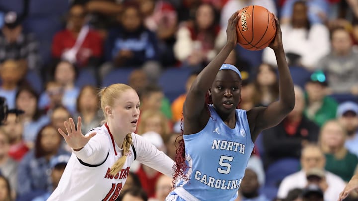 Mar 8, 2025; Greensboro, NC, USA; North Carolina Tar Heels forward Maria Gakdeng (5) sets the play against NC State Wolfpack forward Tilda Trygger (18) during the third quarter at First Horizon Coliseum. Mandatory Credit: Cory Knowlton-Imagn Images