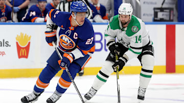 Feb 23, 2025; Elmont, New York, USA; New York Islanders left wing Anders Lee (27) skates with the puck against Dallas Stars left wing Jamie Benn (14) during the second period at UBS Arena. Mandatory Credit: Brad Penner-Imagn Images