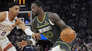 Minnesota Timberwolves forward Julius Randle works past Phoenix Suns guard Ryan Dunn in the first quarter at Target Center in Minneapolis on March 28, 2025.