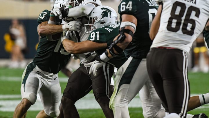 MSU DT Alex VanSumeren (97) and LB Ben VanSumeren tackle LB Zaire Barnes WMU RB La'Darius Jefferson Friday, Sept. 2, 2022, during the season opener at Spartan Stadium.

Dsc 6796