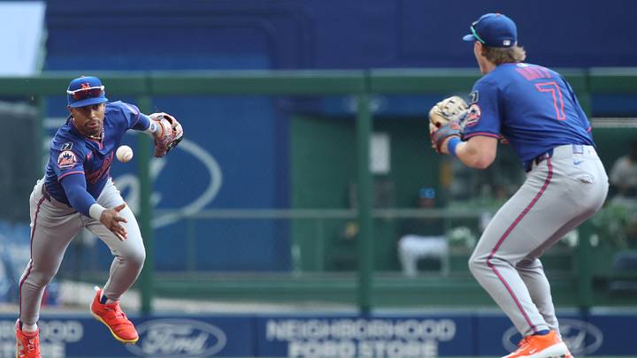 Jun 28, 2025; Pittsburgh, Pennsylvania, USA;  New York Mets shortstop Francisco Lindor (12) flips the ball to second baseman Brett Baty (7) for a force-out at second base to end the first inning against the Pittsburgh Pirates at PNC Park. Mandatory Credit: Charles LeClaire-Imagn Images
