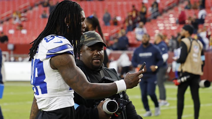 Dallas Cowboys wide receiver CeeDee Lamb records a phone video while leaving the field after the Cowboys' game against the Washington Commanders.