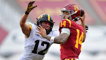 Nov 15, 2025; Los Angeles, California, USA; Iowa Hawkeyes defensive back Jaxon Rexroth (12) moves in against Southern California Trojans quarterback Jayden Maiava (14) during the second half at the Los Angeles Memorial Coliseum. Mandatory Credit: Gary A. Vasquez-Imagn Images
