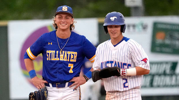 MLB prospects Eli Willits (right) and Ethan Holliday stand at second base staring at the dugout