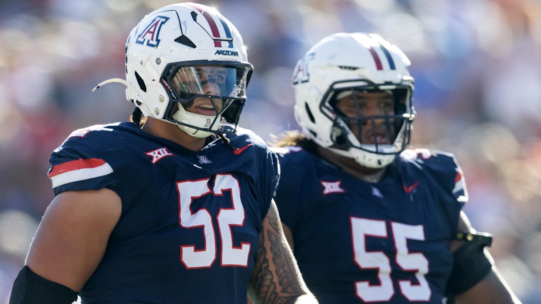 Nov 8, 2025; Tucson, Arizona, USA; Arizona Wildcats offensive lineman Ka'ena Decambra (52) and Chubba Maae (55) against the Kansas Jayhawks at Arizona Stadium. Mandatory Credit: Mark J. Rebilas-Imagn Images