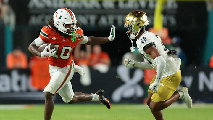 Aug 31, 2025; Miami Gardens, Florida, USA; Miami Hurricanes wide receiver Malachi Toney (10) runs with the football against Notre Dame Fighting Irish cornerback Karson Hobbs (21) during the first half at Hard Rock Stadium. Mandatory Credit: Sam Navarro-Imagn Images